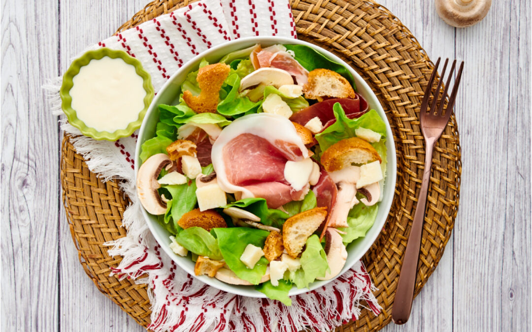 Caesar salad with prosciutto and sliced raw mushrooms