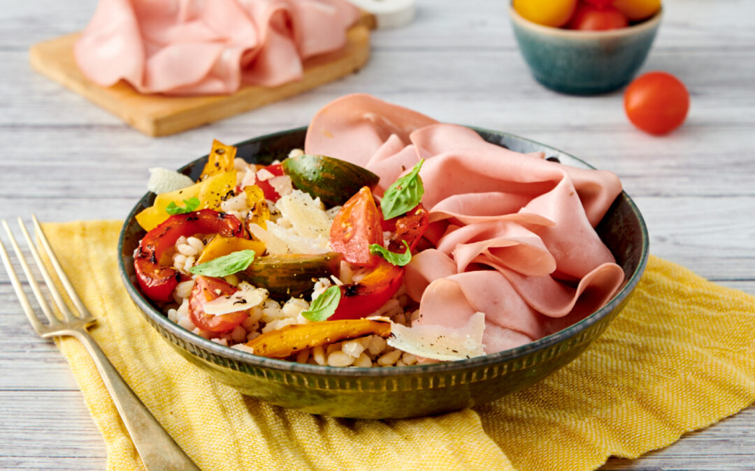 Barley salad with mortadella, peppers, cherry tomatoes and Parmigiano Reggiano cheese
